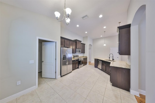 838 Vino Verde Cir, Brandon, FL 33511 - kitchen with dark brown cabinets, visible vents, appliances with stainless steel finishes, arched walkways, and a sink