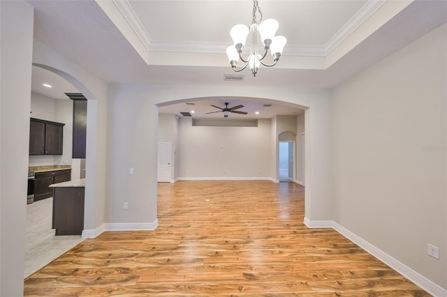 838 Vino Verde Cir, Brandon, FL 33511 - interior space with crown molding, light wood-style flooring, arched walkways, and ceiling fan with notable chandelier