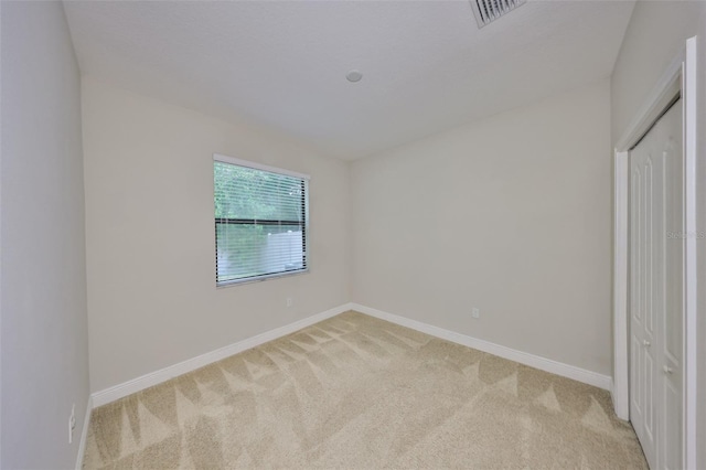 838 Vino Verde Cir, Brandon, FL 33511 - unfurnished bedroom featuring light carpet, visible vents, baseboards, and a closet