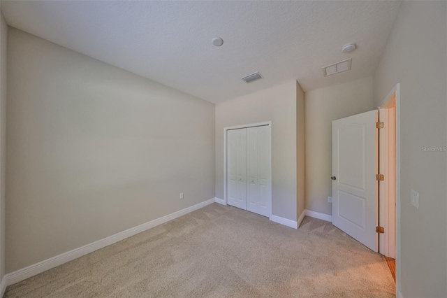 838 Vino Verde Cir, Brandon, FL 33511 - unfurnished bedroom with a closet, visible vents, light colored carpet, and baseboards