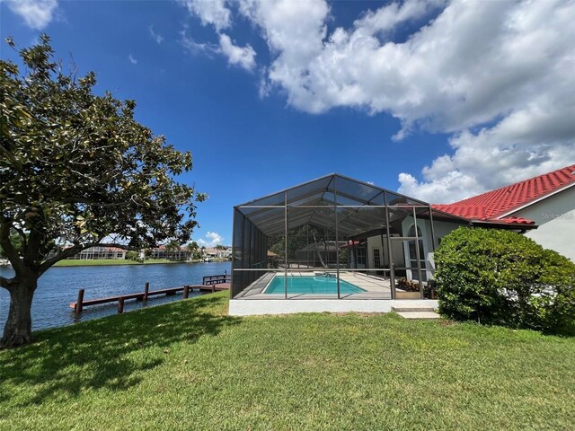 4804 Longwater Way, Tampa, FL 33615 - outdoor pool featuring a lawn, a water view, and glass enclosure