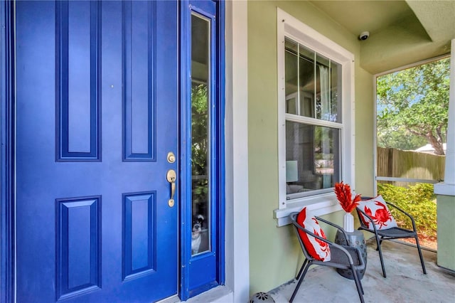 3408 W Bay Ave, Tampa, FL 33611 - doorway to property featuring fence and stucco siding