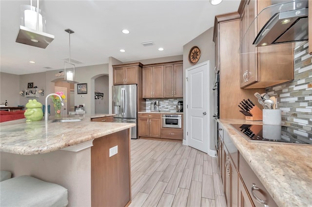 3408 W Bay Ave, Tampa, FL 33611 - kitchen with tasteful backsplash, arched walkways, stainless steel appliances, a sink, and ventilation hood