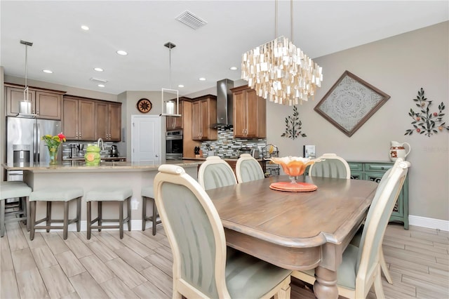 3408 W Bay Ave, Tampa, FL 33611 - dining room featuring recessed lighting, a chandelier, wood tiled floor, visible vents, and baseboards