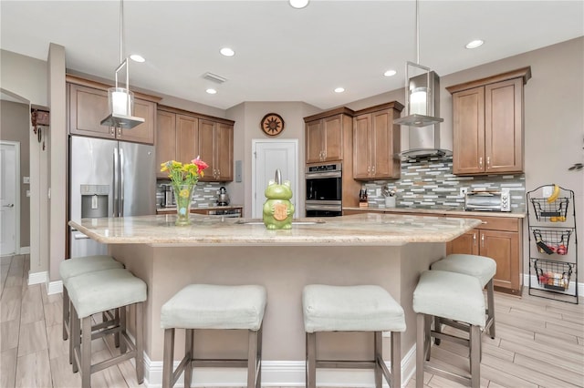 3408 W Bay Ave, Tampa, FL 33611 - kitchen featuring appliances with stainless steel finishes, a breakfast bar, range hood, and backsplash
