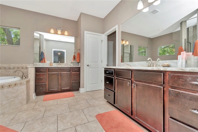 3408 W Bay Ave, Tampa, FL 33611 - full bath with a sink, visible vents, two vanities, a garden tub, and tile patterned flooring