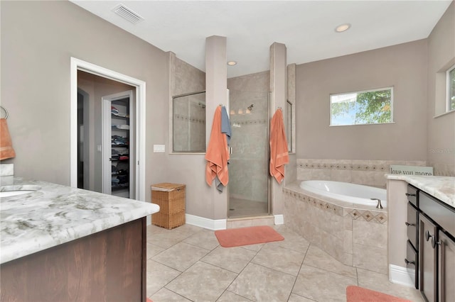 3408 W Bay Ave, Tampa, FL 33611 - bathroom featuring vanity, a stall shower, visible vents, a garden tub, and tile patterned flooring