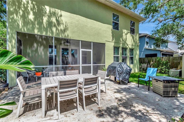 3408 W Bay Ave, Tampa, FL 33611 - view of patio featuring area for grilling, outdoor dining area, and fence
