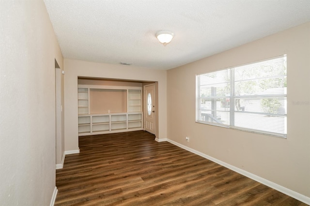 1602 E New Orleans Ave, Tampa, FL 33610 - empty room with dark wood-style floors and a textured ceiling