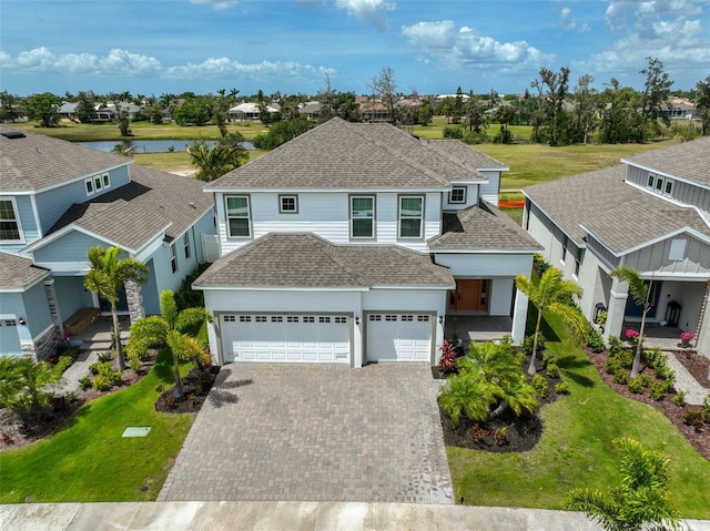 view of front facade featuring a residential view, a front yard, and roof with shingles
