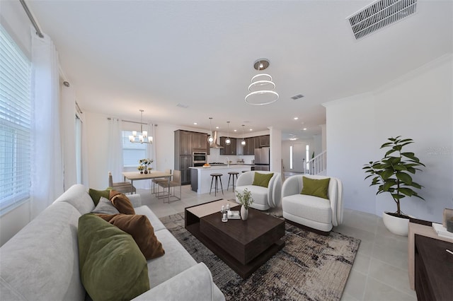 living room with visible vents, a notable chandelier, recessed lighting, and light tile patterned floors