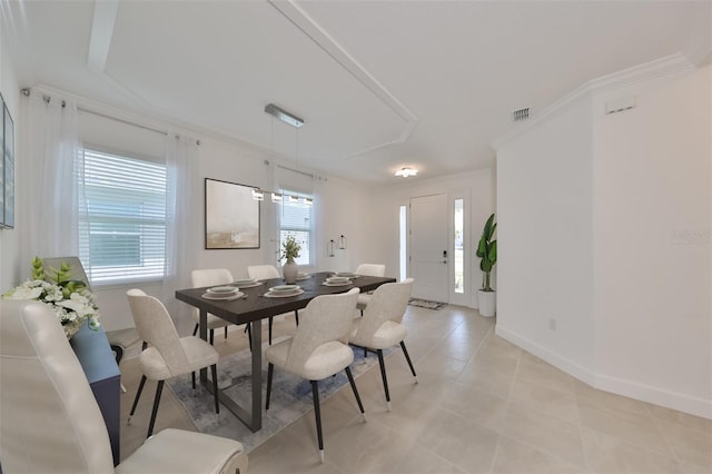 dining space with light tile patterned floors, ornamental molding, baseboards, and visible vents