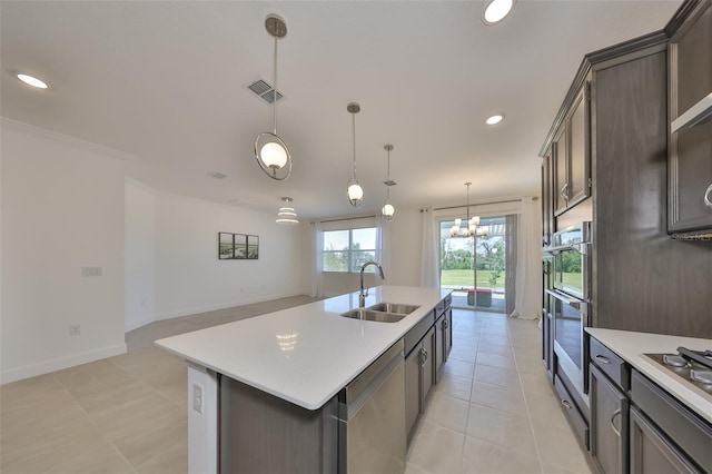 kitchen featuring visible vents, light countertops, a sink, and stainless steel appliances