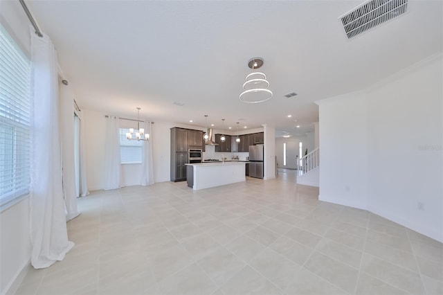 unfurnished living room featuring visible vents, recessed lighting, and a notable chandelier