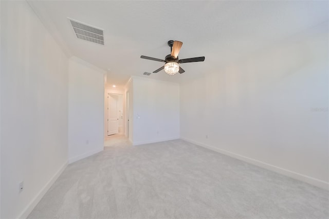 unfurnished room featuring light carpet, baseboards, visible vents, and ceiling fan