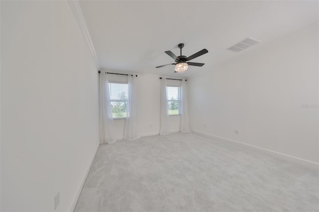 unfurnished room with light carpet, baseboards, visible vents, and ceiling fan