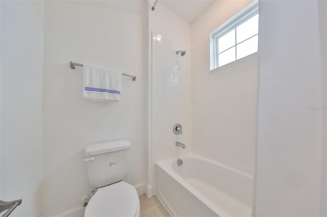 full bath featuring toilet, tile patterned flooring, baseboards, and washtub / shower combination
