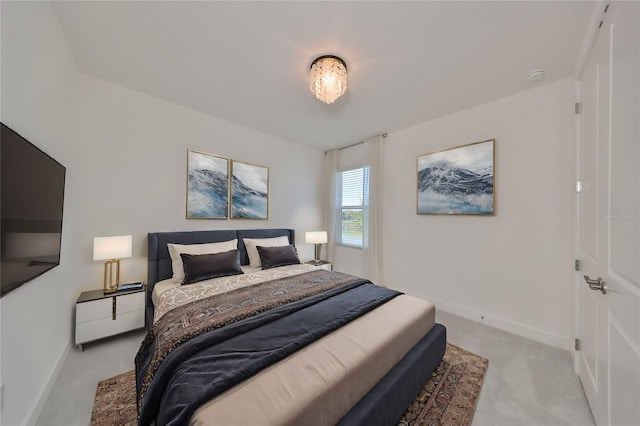 bedroom with light carpet and baseboards