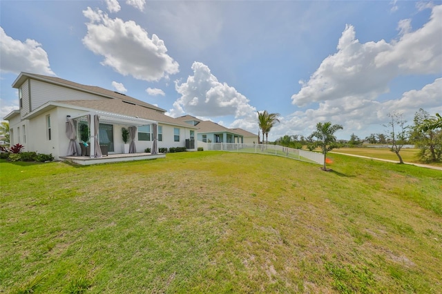 rear view of property featuring a patio, fence, a lawn, and central AC