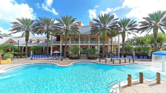 pool featuring fence and a patio