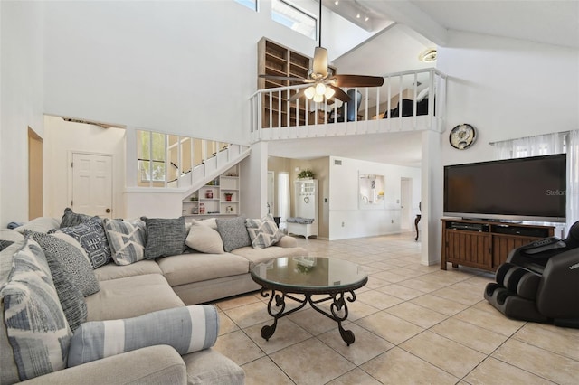 living area with high vaulted ceiling, stairway, a ceiling fan, tile patterned flooring, and beam ceiling