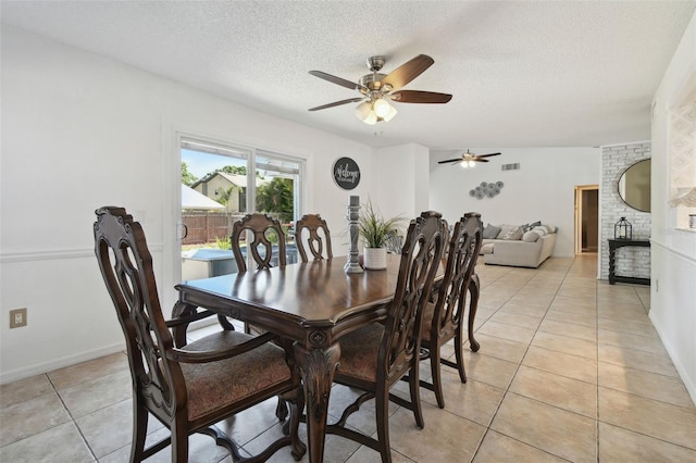 dining space with visible vents, a ceiling fan, light tile patterned flooring, baseboards, and a textured ceiling