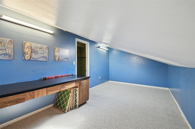 game room with carpet floors, a textured ceiling, and baseboards