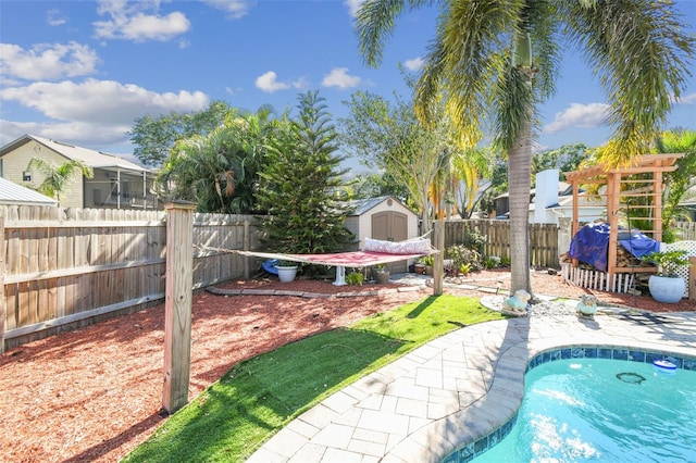 view of pool with an outdoor structure, a fenced in pool, a shed, and a fenced backyard