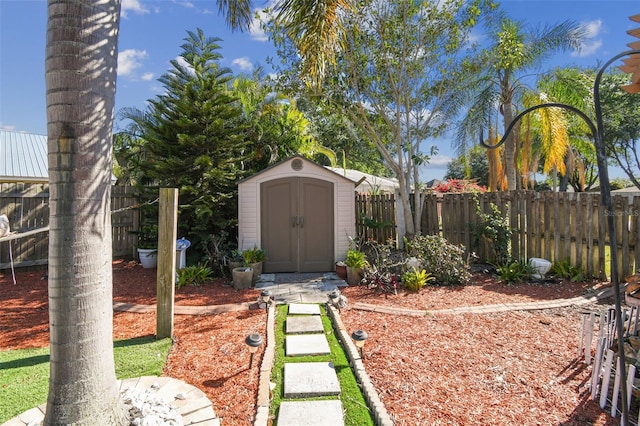view of yard with a storage unit, an outbuilding, and fence