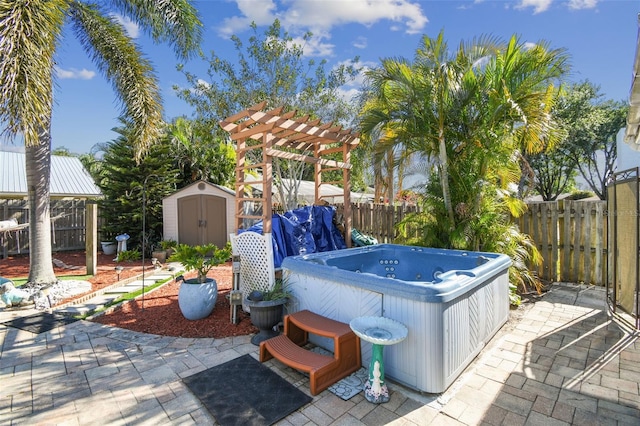 view of patio / terrace with a pergola, a fenced backyard, an outbuilding, a storage unit, and a hot tub