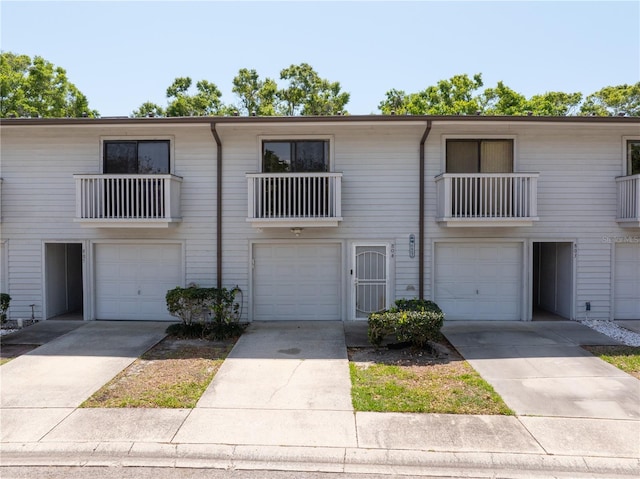 townhome / multi-family property with driveway and a garage