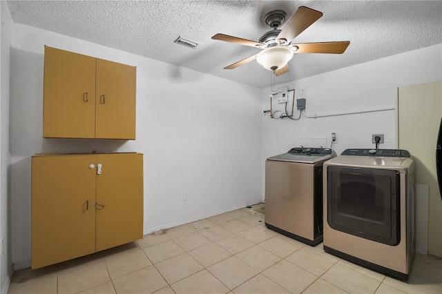 washroom featuring washer and clothes dryer, a textured ceiling, cabinet space, visible vents, and ceiling fan