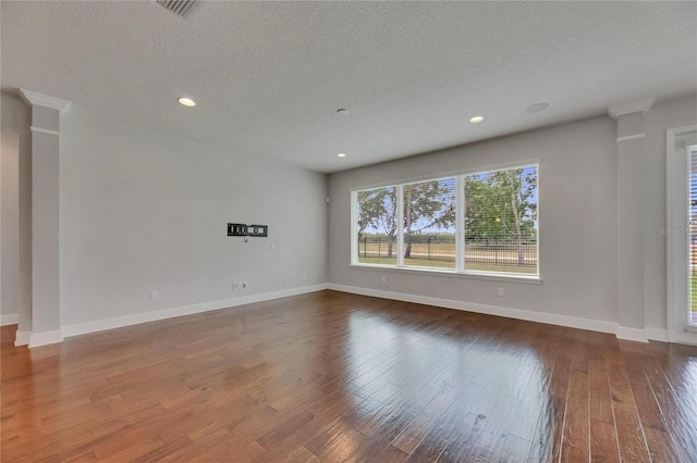 6611 Current Dr, Apollo Beach, FL 33572 - spare room with wood finished floors, a textured ceiling, baseboards, and recessed lighting