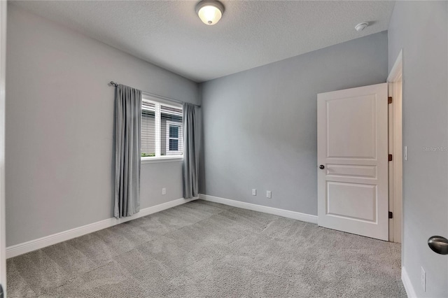 6611 Current Dr, Apollo Beach, FL 33572 - empty room with a textured ceiling, carpet, a smoke detector, and baseboards