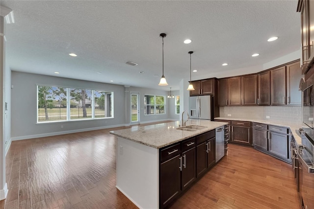 6611 Current Dr, Apollo Beach, FL 33572 - kitchen featuring stainless steel appliances, plenty of natural light, baseboards, a sink, and recessed lighting