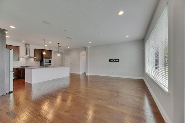 6611 Current Dr, Apollo Beach, FL 33572 - unfurnished living room with dark wood-style flooring, recessed lighting, and baseboards