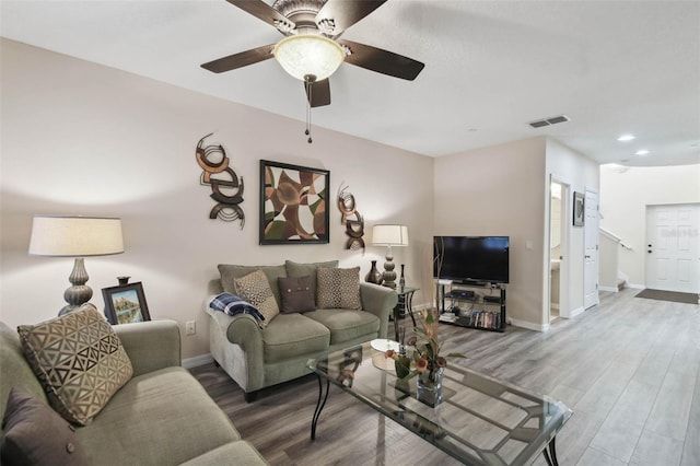 living area featuring wood finished floors, baseboards, and visible vents