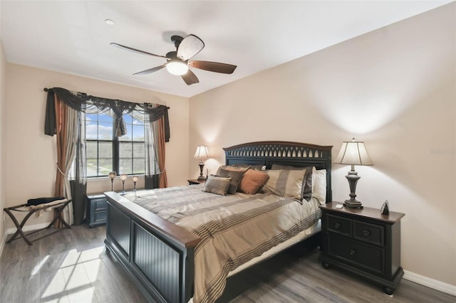 bedroom featuring baseboards, ceiling fan, and wood finished floors
