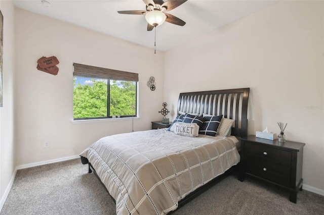 bedroom with baseboards, dark carpet, and a ceiling fan