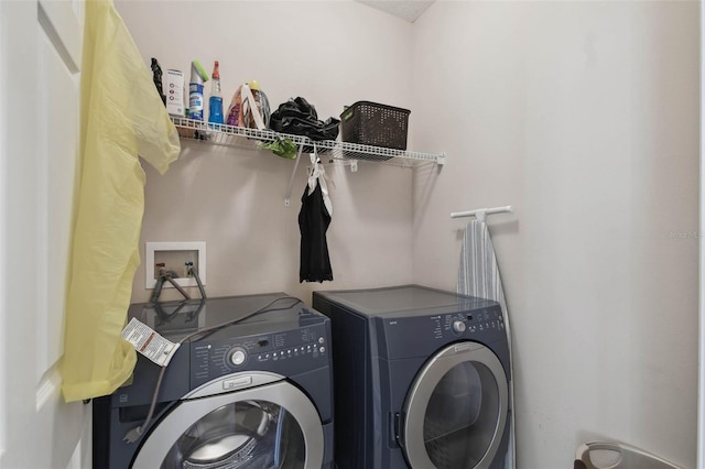 washroom featuring washing machine and clothes dryer and laundry area
