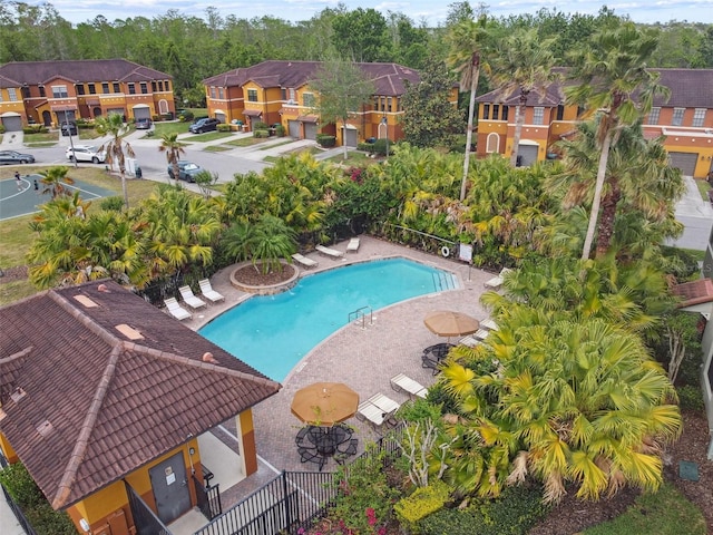 pool featuring a residential view, fence, and a patio