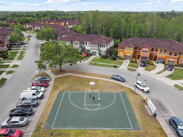 drone / aerial view with a residential view and a view of trees