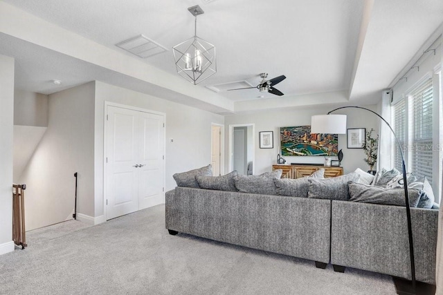 10703 Morning Dew Way, Tampa, FL 33647 - living room featuring carpet flooring, a tray ceiling, baseboards, and ceiling fan
