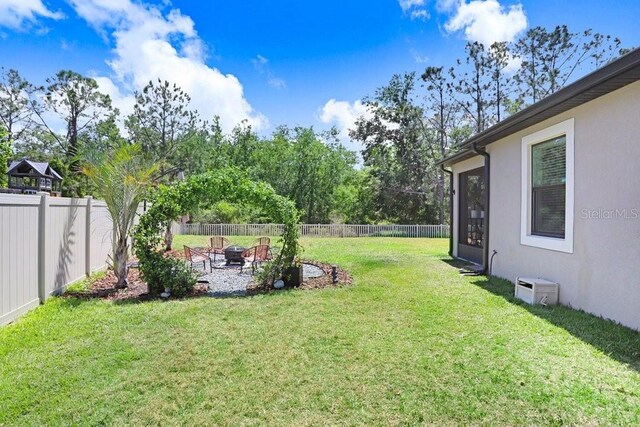 10703 Morning Dew Way, Tampa, FL 33647 - view of yard featuring a fenced backyard and a fire pit