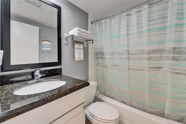 full bathroom with a textured wall, shower / tub combo, vanity, and toilet