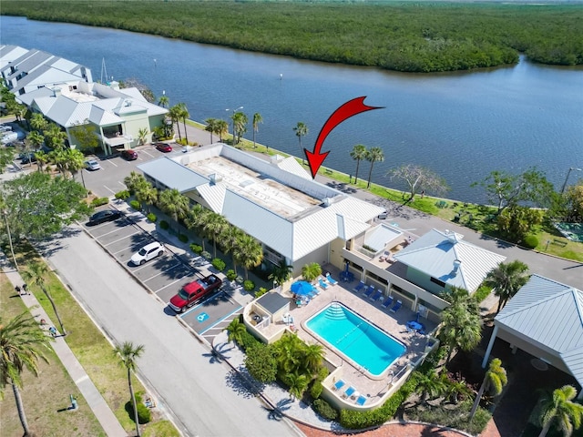 drone / aerial view with a water view and a forest view