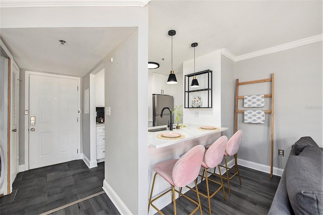 1000 W Horatio St Unit 207, Tampa, FL 33606 - bar with dark wood-style floors, a sink, freestanding refrigerator, baseboards, and hanging light fixtures