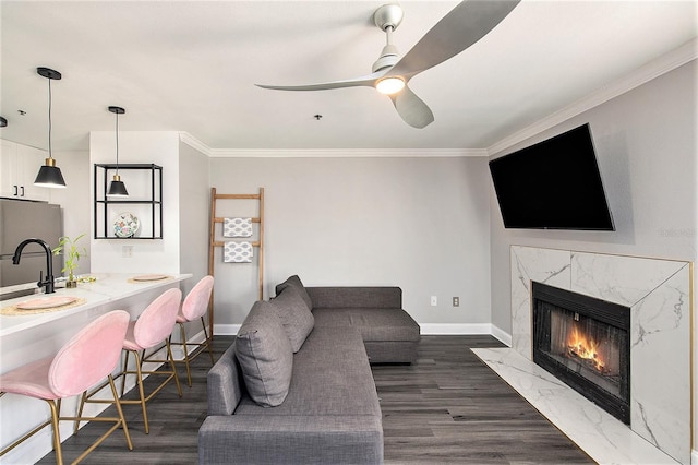 1000 W Horatio St Unit 207, Tampa, FL 33606 - living area featuring dark wood-style flooring, a high end fireplace, ceiling fan, baseboards, and ornamental molding