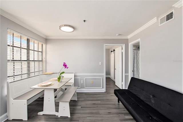 1000 W Horatio St Unit 207, Tampa, FL 33606 - dining room with ornamental molding, a wainscoted wall, dark wood-type flooring, and visible vents