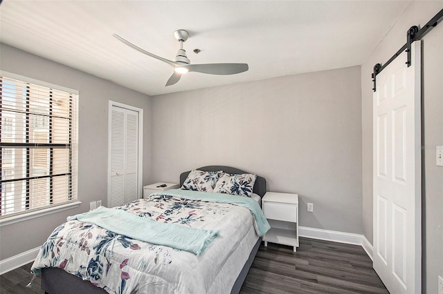 1000 W Horatio St Unit 207, Tampa, FL 33606 - bedroom with baseboards, dark wood finished floors, and a barn door